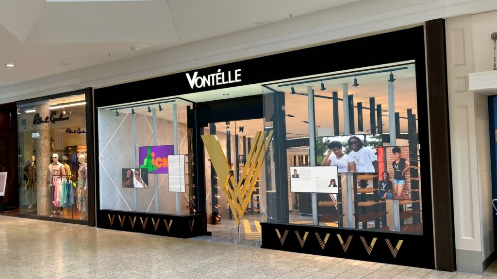 Modern Vontelle retail storefront inside shopping mall with illuminated branding and display windows